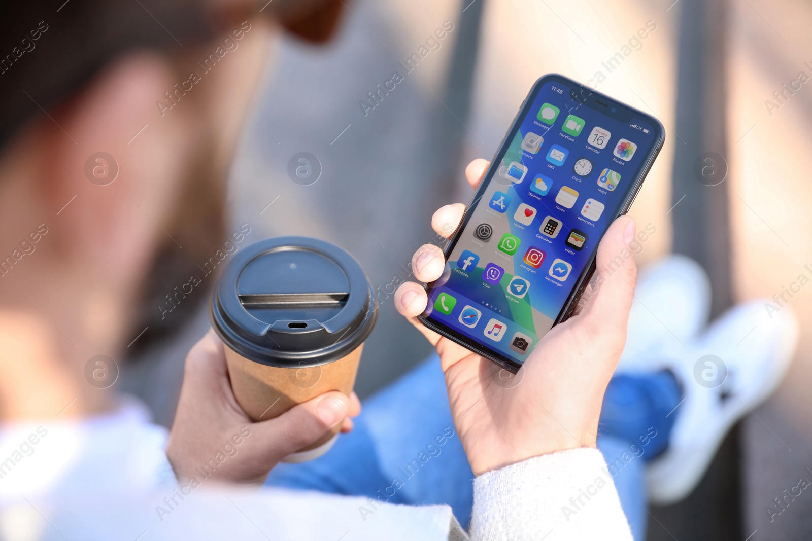 Photo of MYKOLAIV, UKRAINE - MARCH 16, 2020: Man holding iPhone 11 with home screen outdoors, closeup