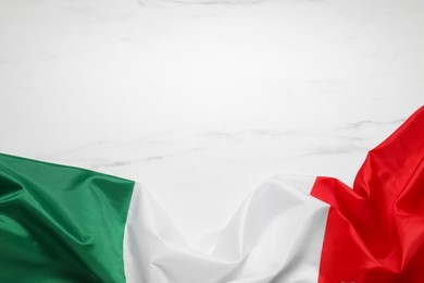 Photo of Flag of Italy on white marble background, top view. Space for text