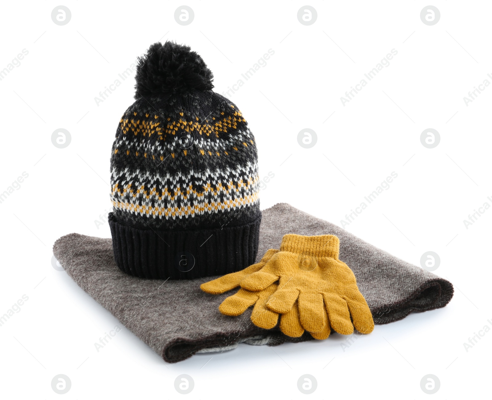 Photo of Woolen gloves, scarf and hat on white background