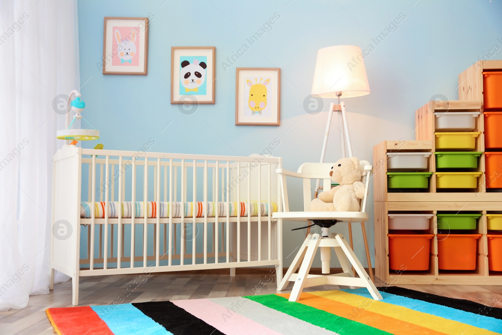 Photo of Modern interior of light cozy baby room with crib