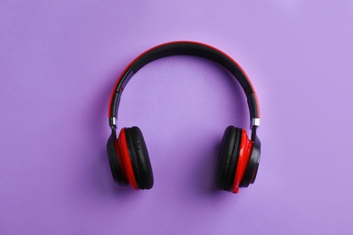 Photo of Wireless headphones on color background, top view