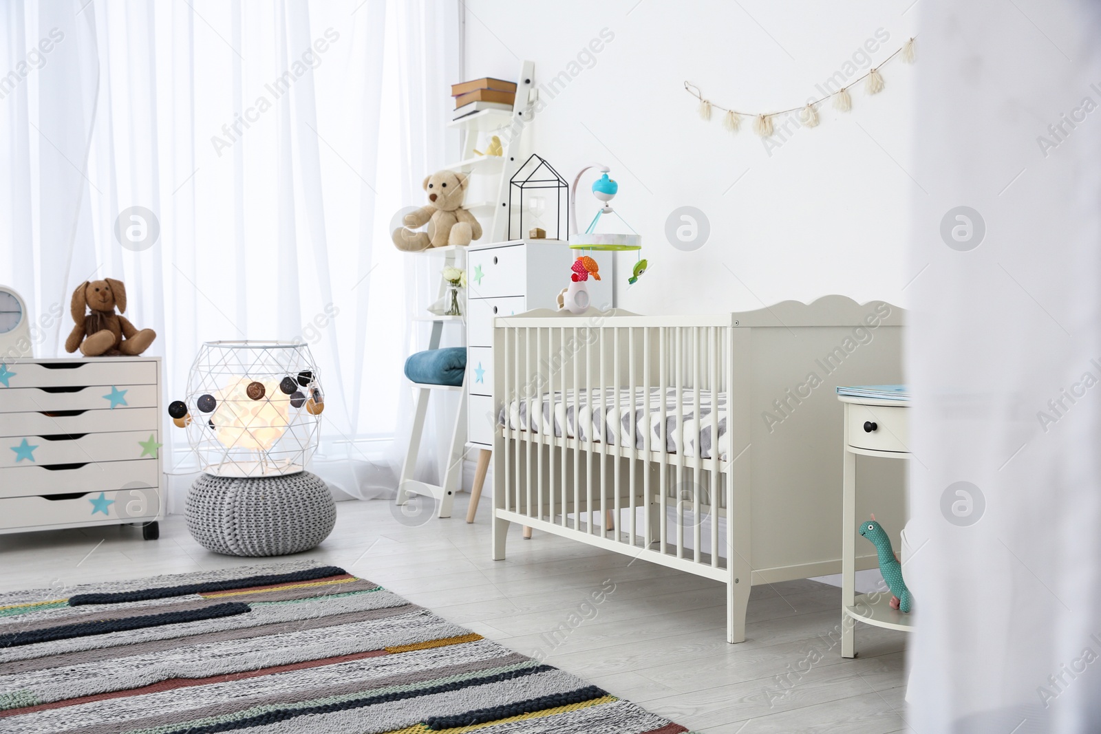 Photo of Cozy baby room interior with crib