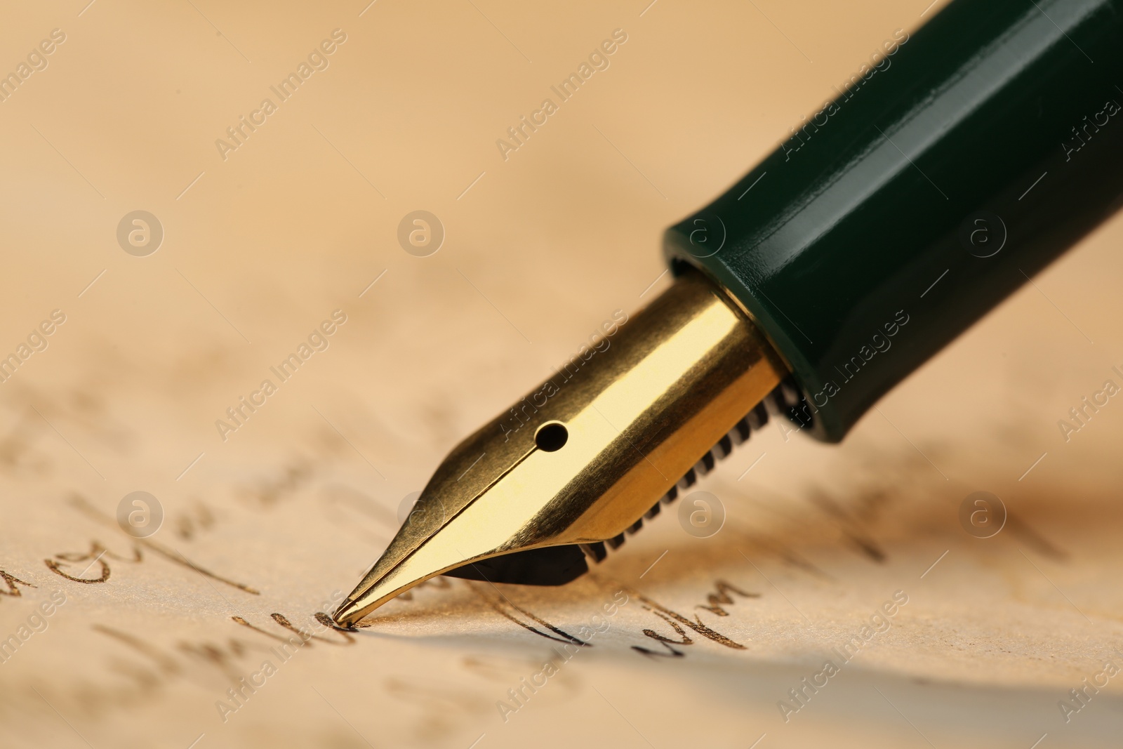 Photo of Writing letter with beautiful fountain pen, closeup