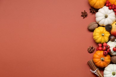 Thanksgiving day. Flat lay composition with pumpkins on brown background, space for text