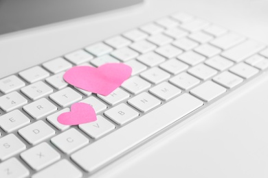 Keyboard with pink hearts on white table. Valentine's day celebration