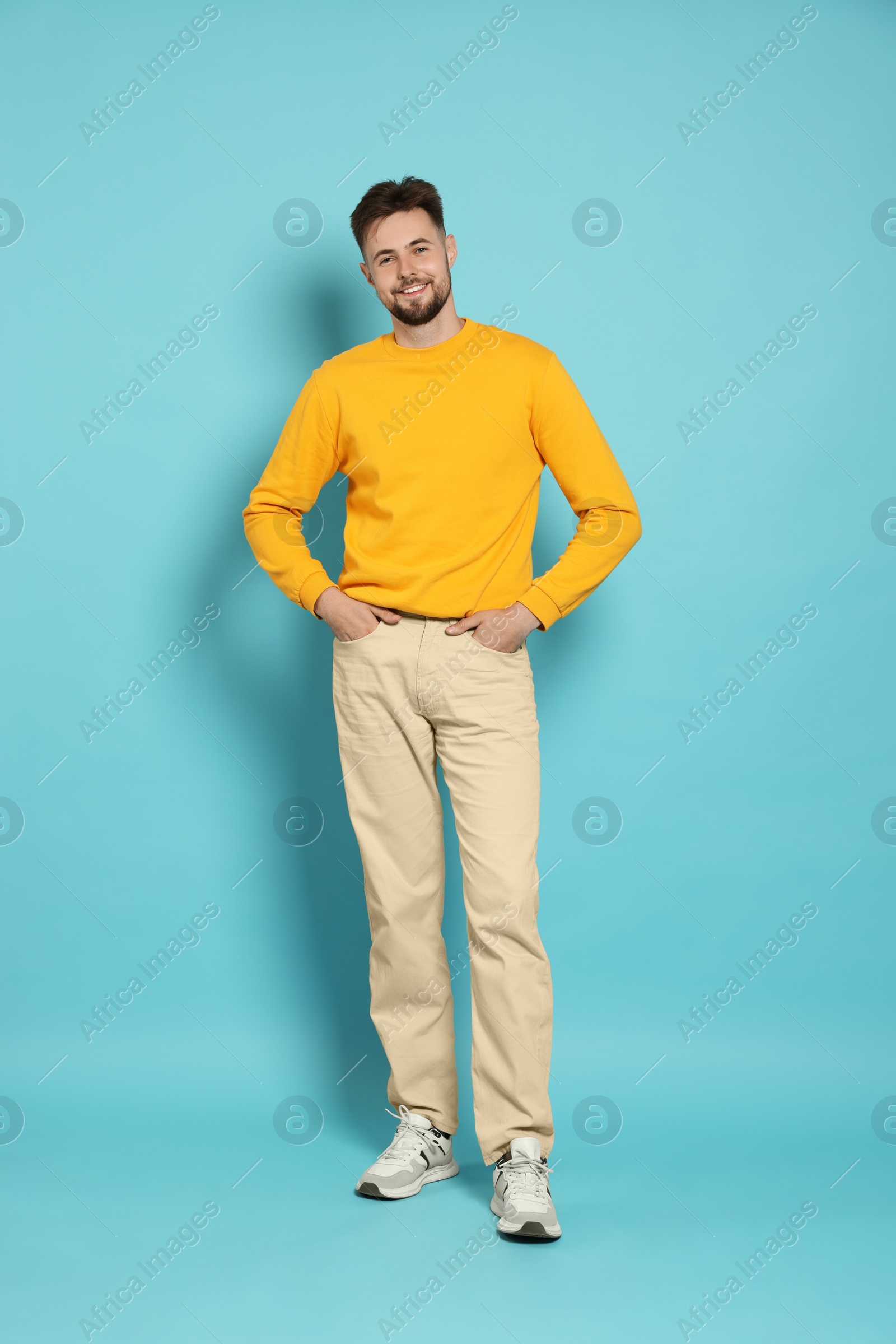 Photo of Full length portrait of handsome man on light blue background