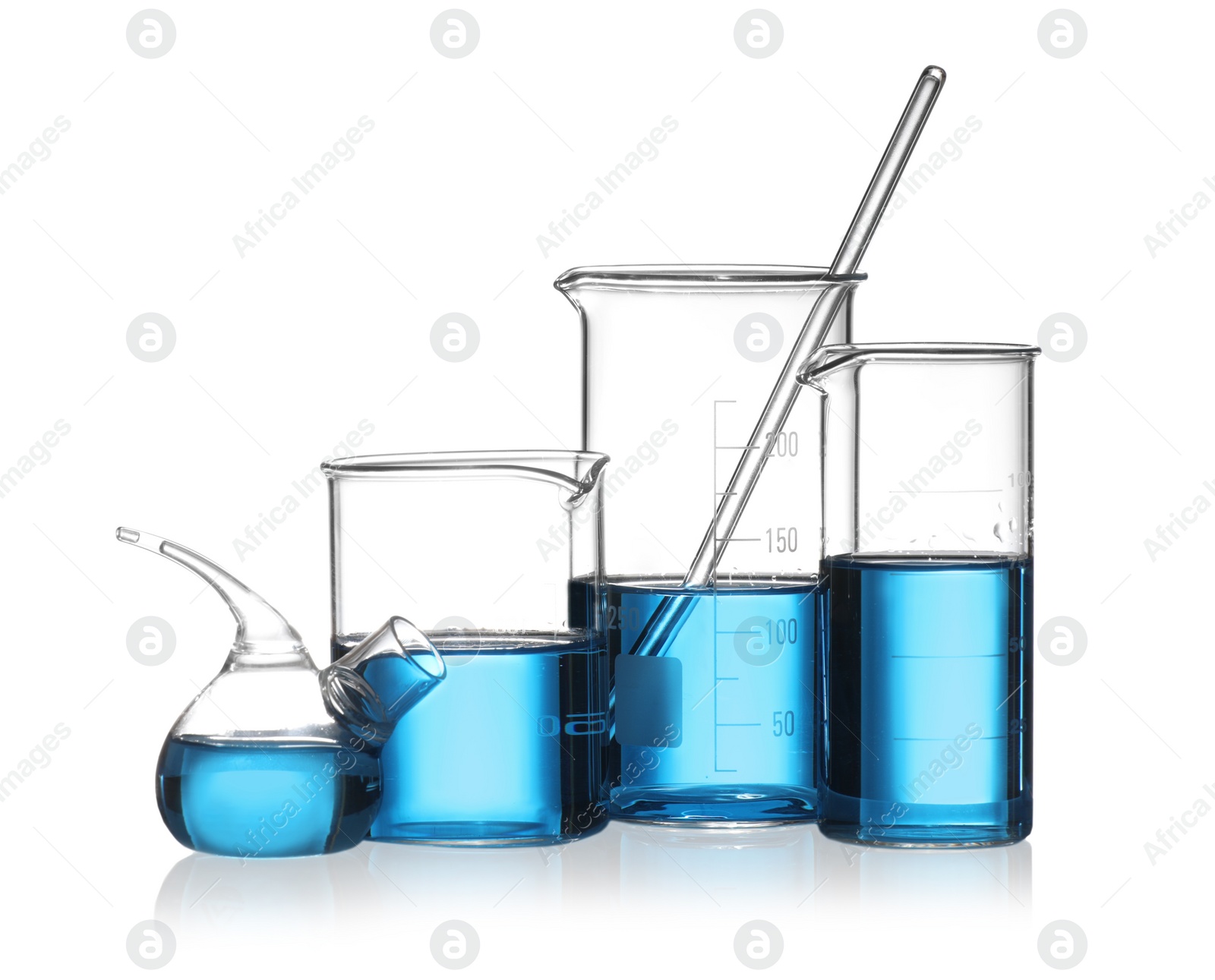 Photo of Set of laboratory glassware with blue liquid isolated on white