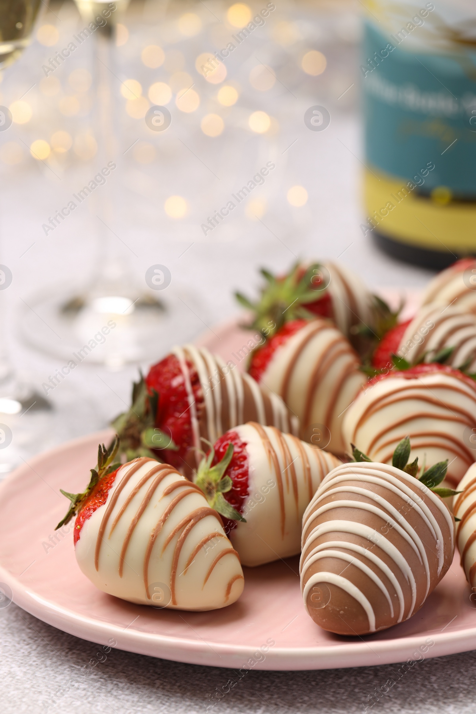 Photo of Delicious chocolate covered strawberries on light table, closeup