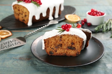 Photo of Traditional Christmas cake on light blue wooden table. Classic recipe