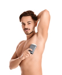 Young man using deodorant on white background