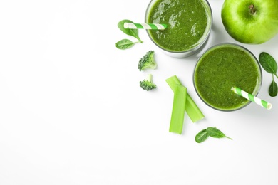 Photo of Delicious green juice and fresh ingredients on white background, flat lay. Space for text