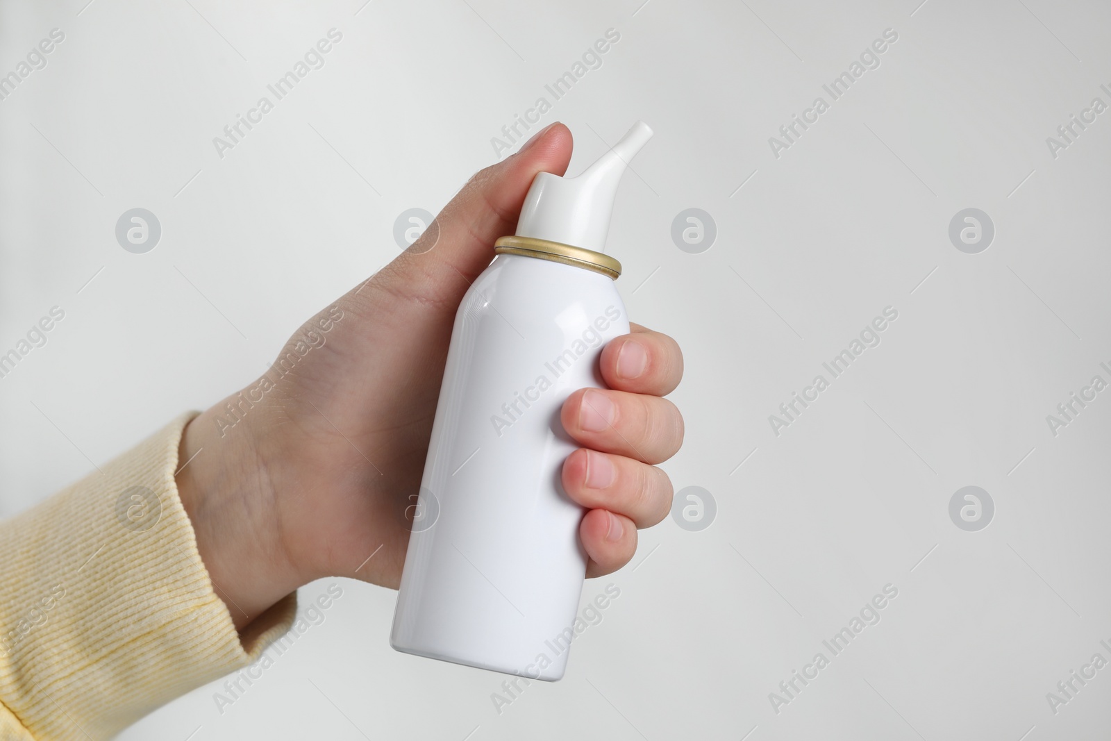 Photo of Woman with nasal spray on white background, closeup