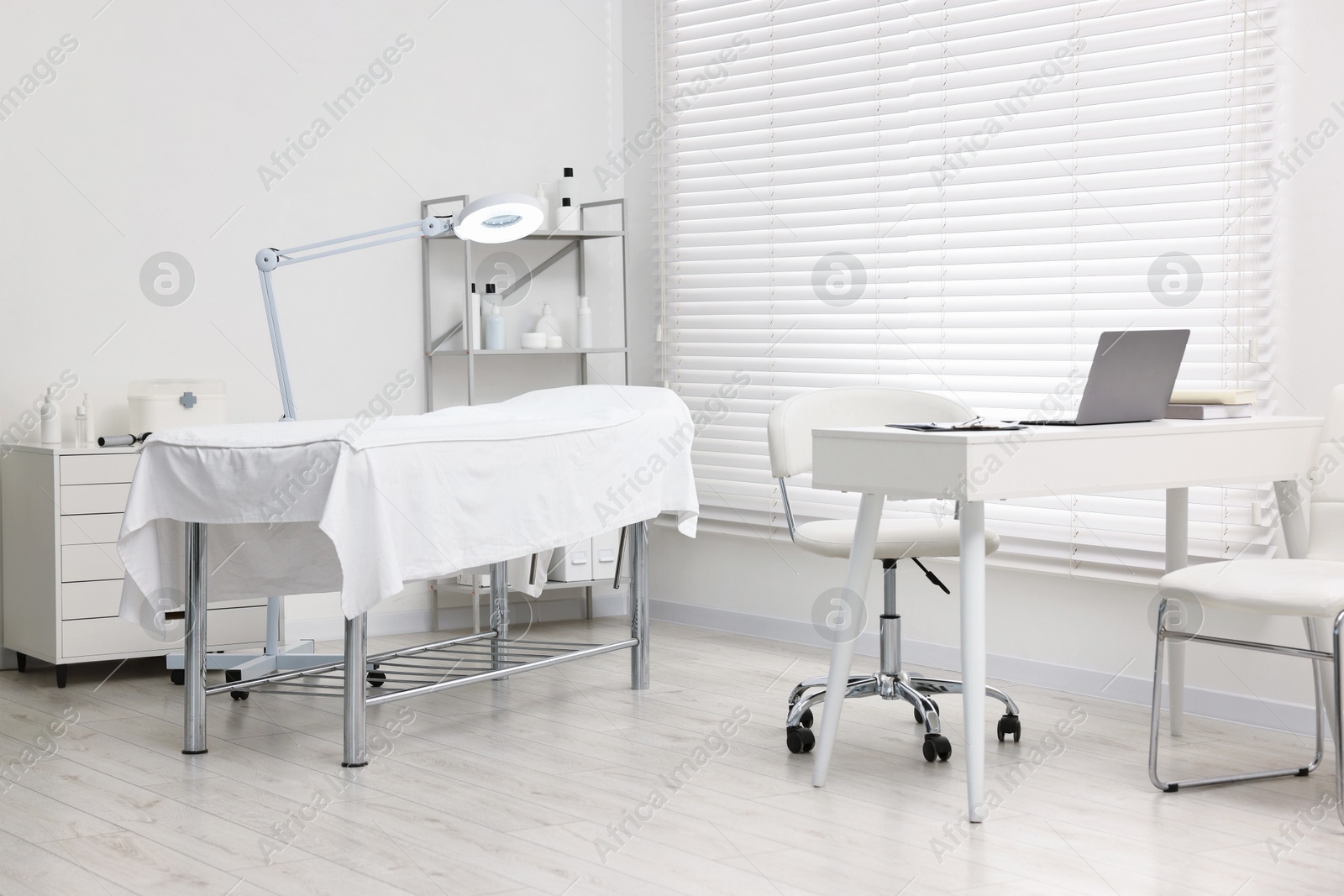 Photo of Modern interior of dermatologist's office with examination table