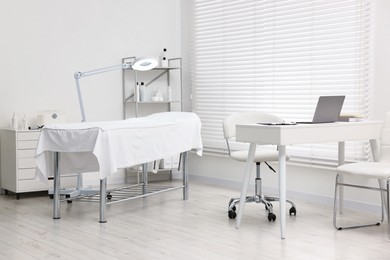 Photo of Modern interior of dermatologist's office with examination table