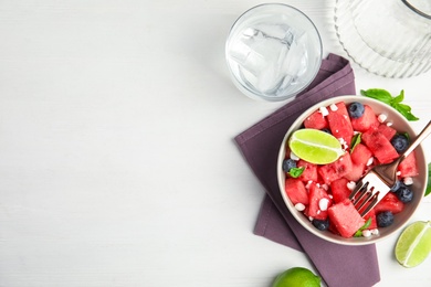 Photo of Delicious salad with watermelon, blueberries and cheese on white wooden table, flat lay. Space for text