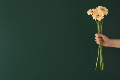 Photo of Woman holding beautiful bouquet near green chalkboard, space for text. Happy Teacher's Day