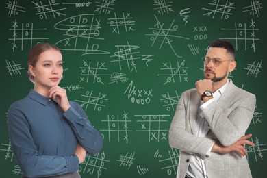 Image of Businesspeople near green chalkboard with drawn tic tac toe game 