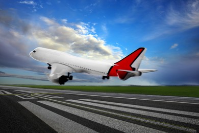 Modern white airplane landing on runway 