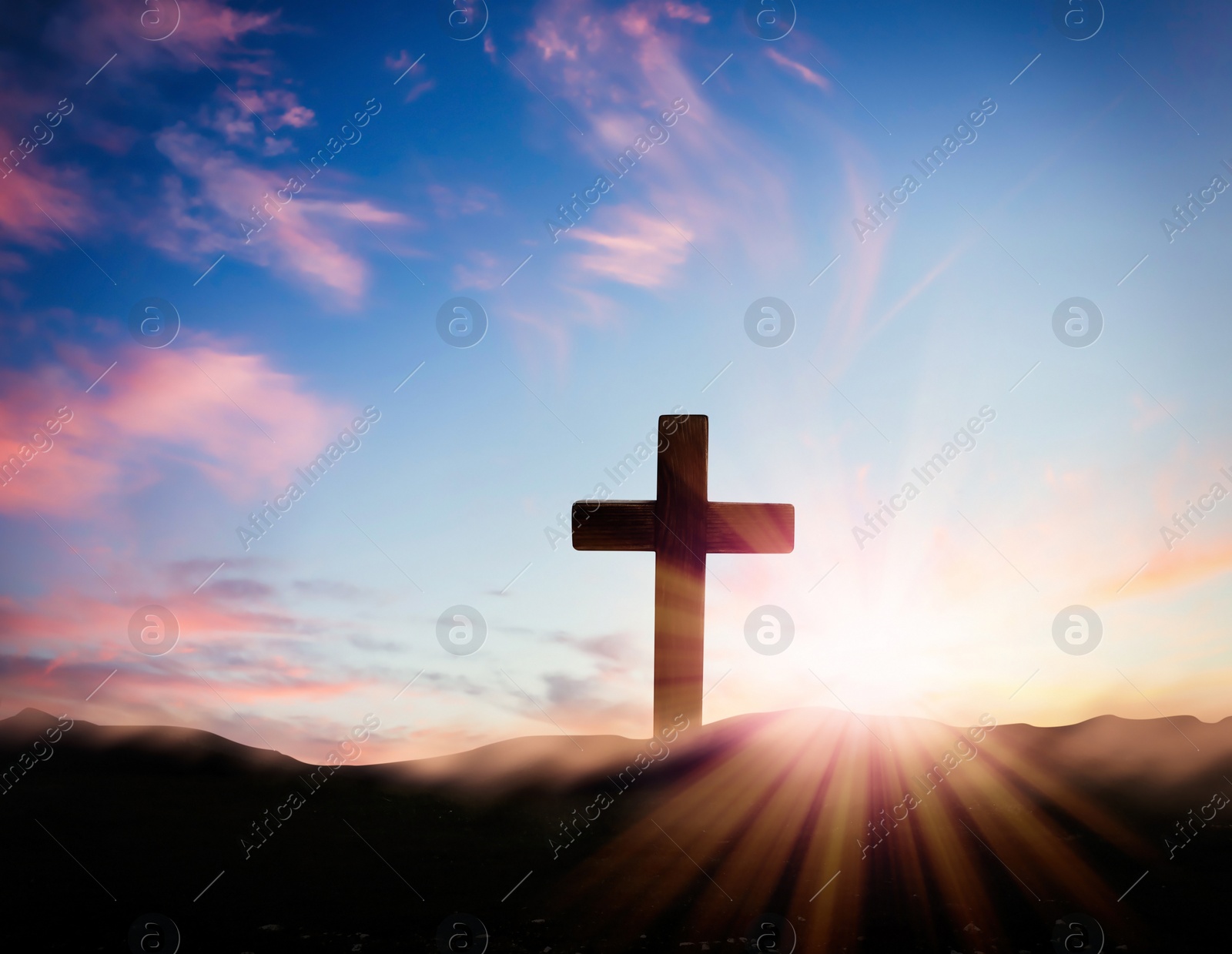 Image of Christian cross on hill outdoors at sunrise. Resurrection of Jesus