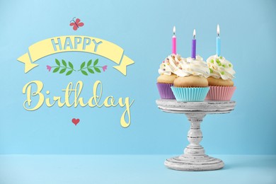 Image of Happy Birthday! Delicious cupcakes with candles on light blue background 