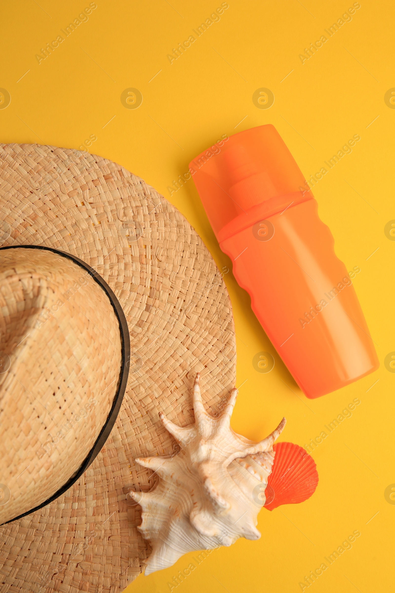 Photo of Flat lay composition with bottle of sunscreen on yellow background