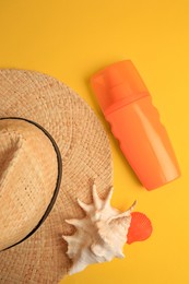 Flat lay composition with bottle of sunscreen on yellow background
