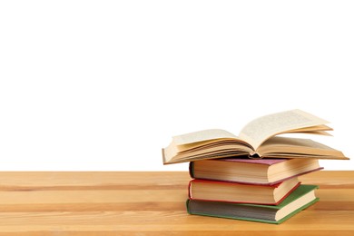 Stack of books on wooden table against white background. Library material