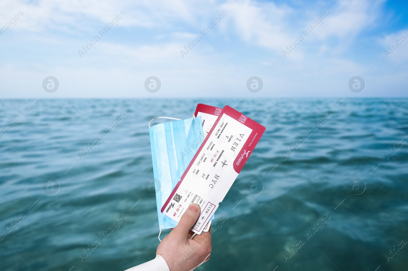 Image of Man holding tickets and protective mask outdoors, closeup. Travel during quarantine