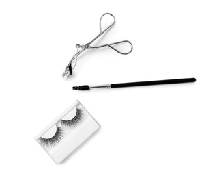 Photo of Composition with false eyelashes and curler on white background, flat lay