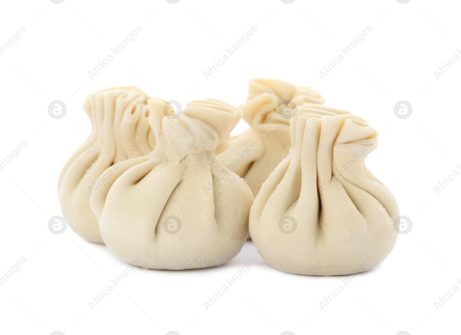 Photo of Heap of raw dumplings with tasty filling on white background