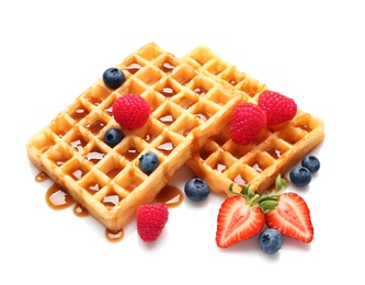 Photo of Yummy waffles with berries and caramel syrup on white background