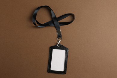 Photo of Blank badge on brown background, top view. Mockup for design
