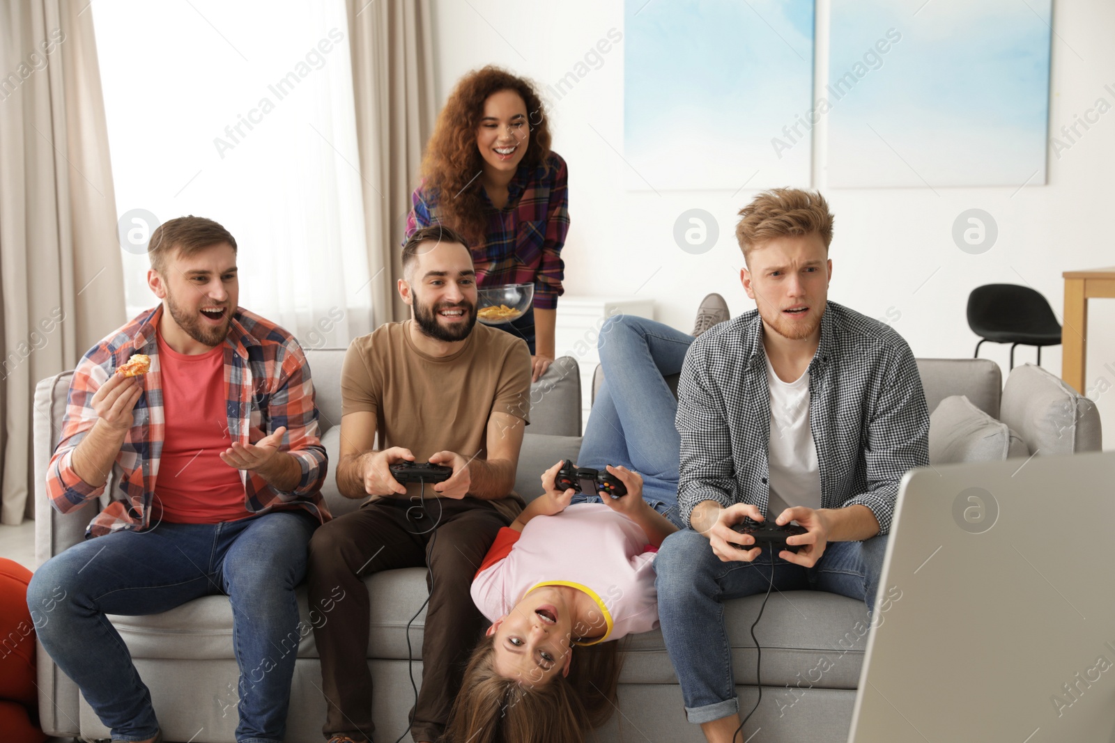 Photo of Emotional friends playing video games at home