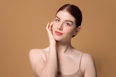 Portrait of beautiful woman on beige background