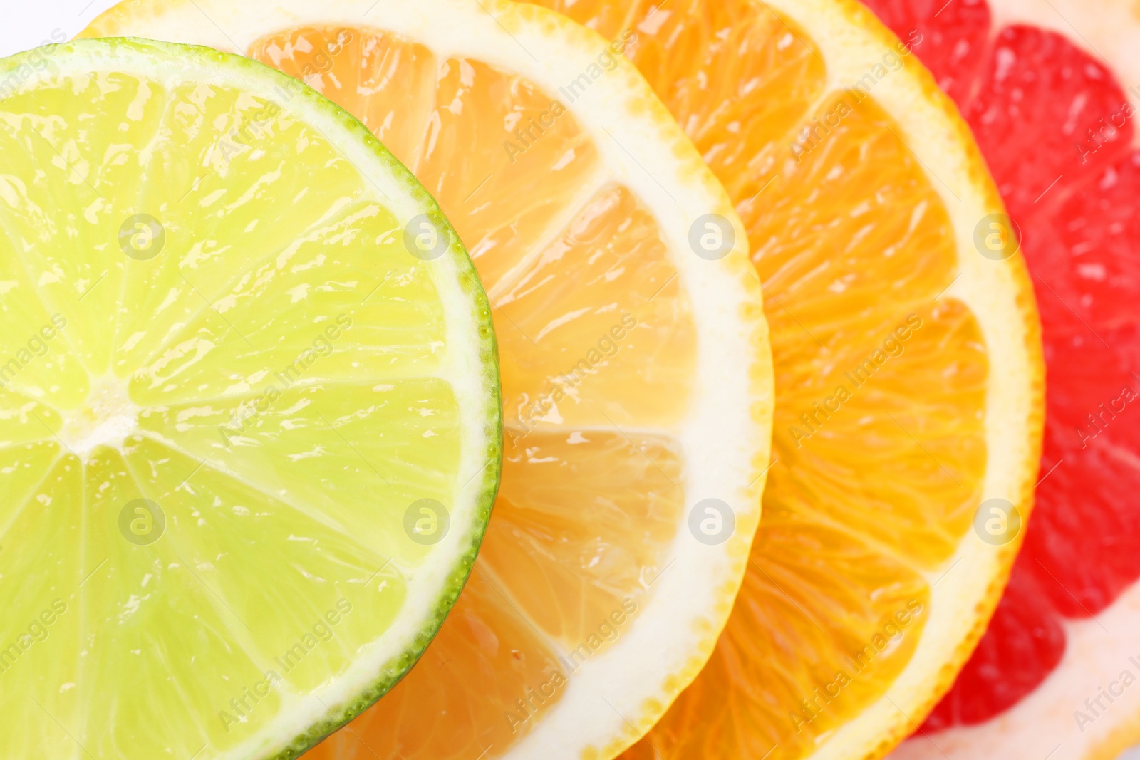 Photo of Slices of fresh ripe citrus fruits as background, top view