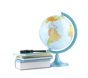 Photo of Plastic model globe of Earth, books and magnifying glass on white background. Geography lesson