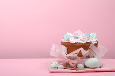 Photo of Traditional Easter cake with meringues and painted eggs on pink background, space for text