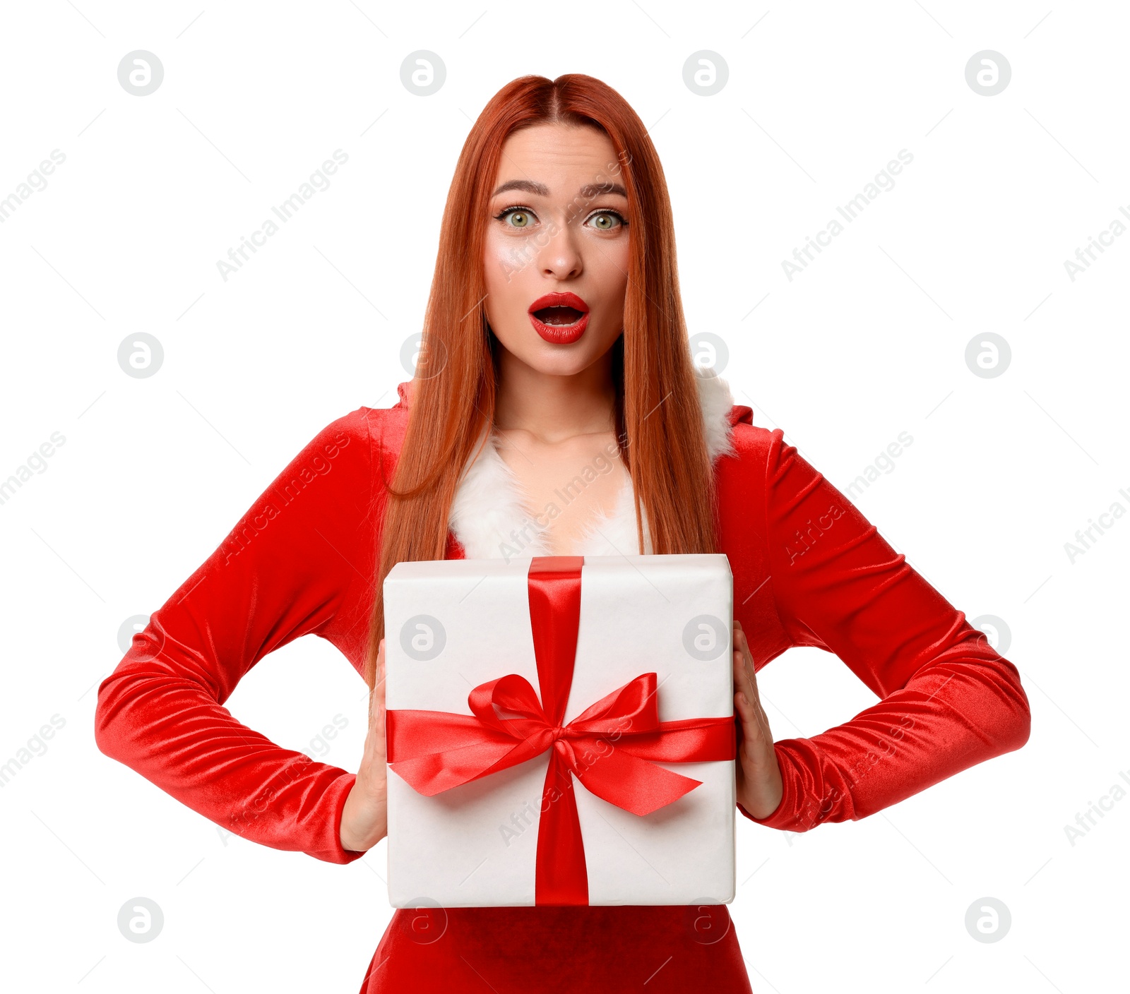 Photo of Emotional young woman in red dress with Christmas gift on white background