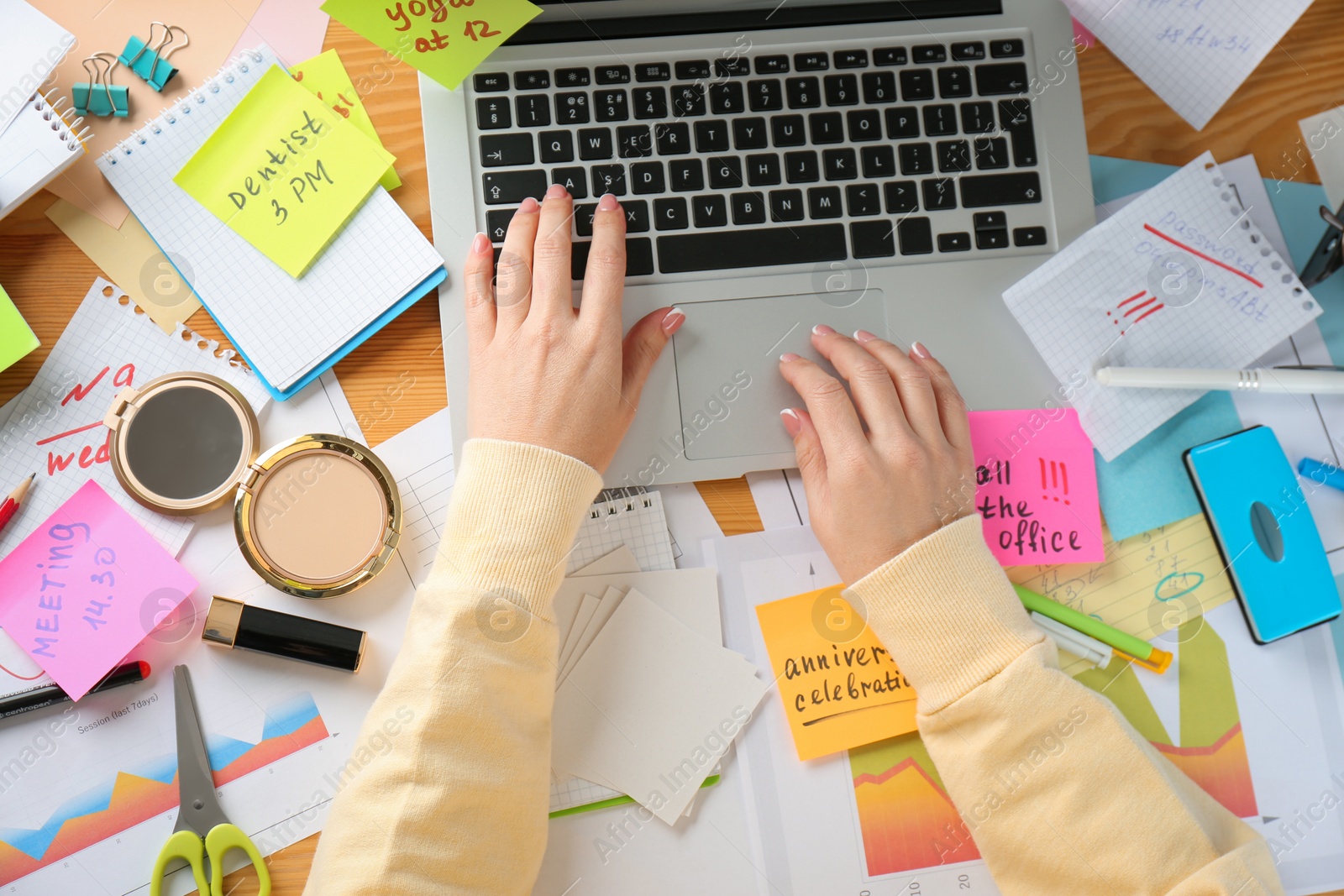 Photo of Woman using laptop at messy table, top view. Concept of being overwhelmed by work