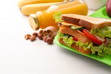 Photo of Serving tray of healthy food and space for text on white wooden table, closeup. School lunch
