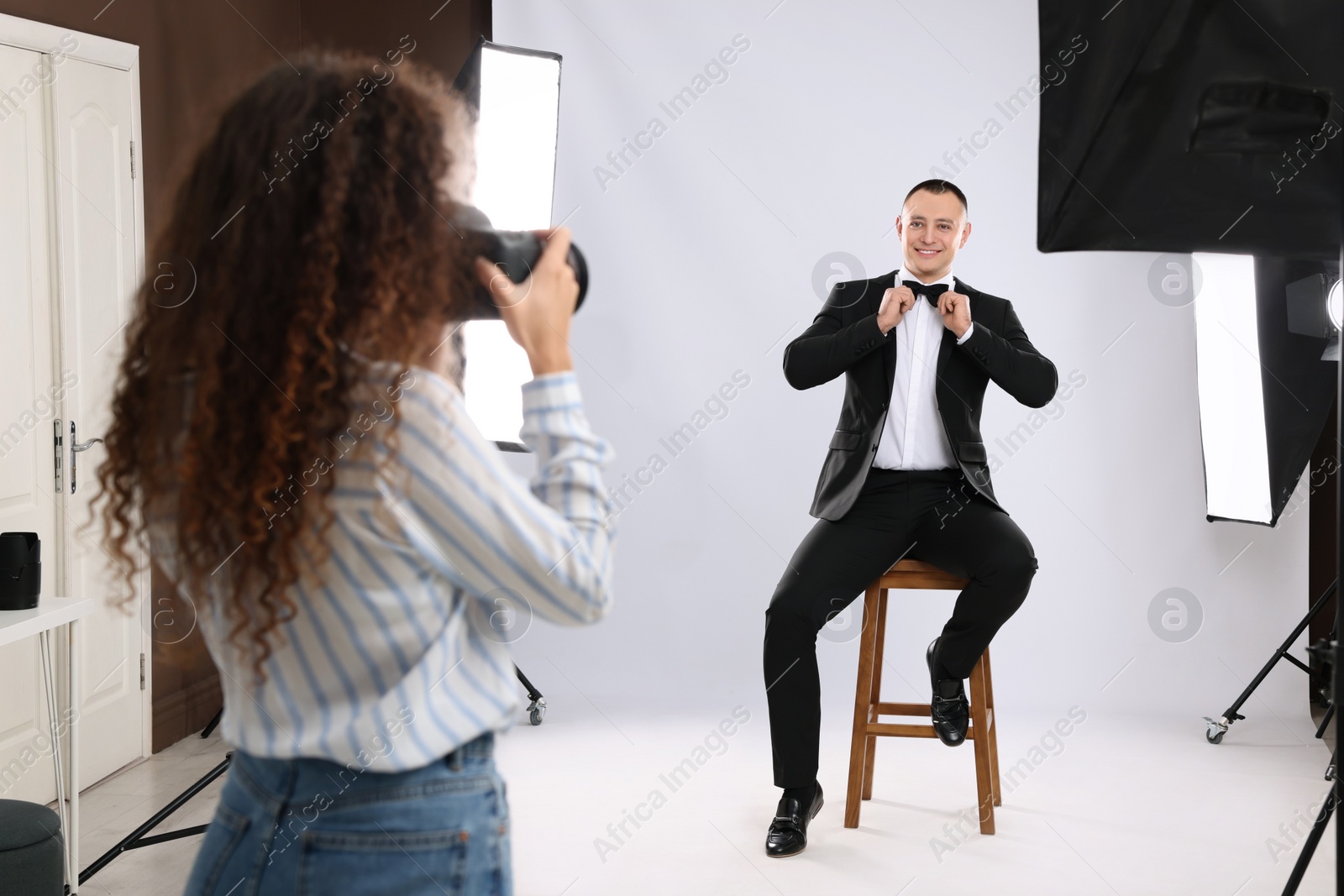 Photo of Handsome model posing for professional photographer in studio