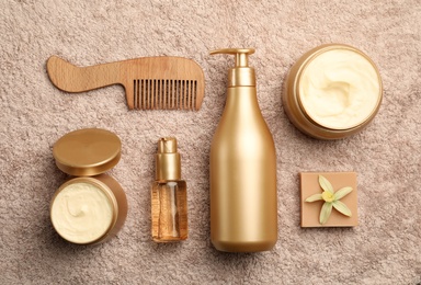 Flat lay composition with hair cosmetic products on towel