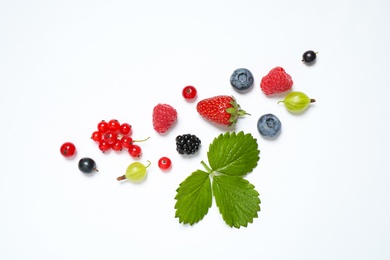 Mix of fresh berries on white background, flat lay