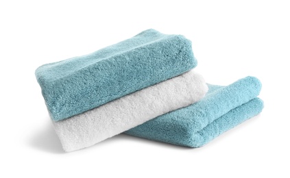 Photo of Stack of clean soft towels on white background