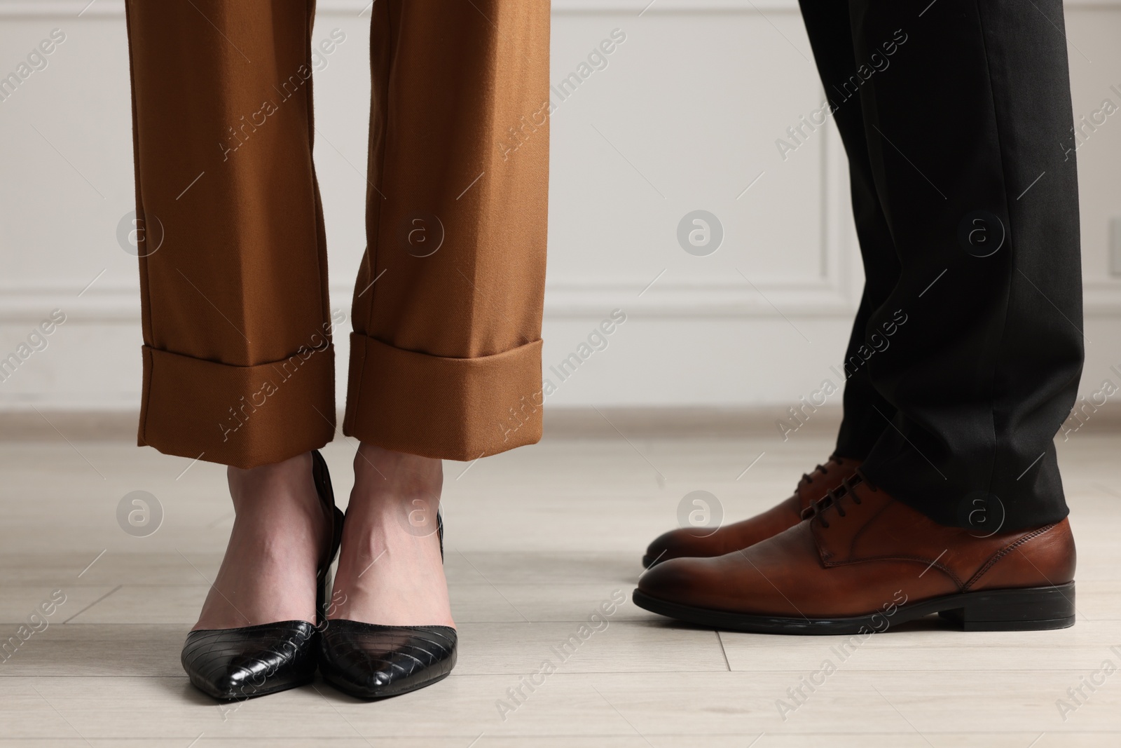 Photo of Businessman and businesswoman in elegant shoes indoors, closeup