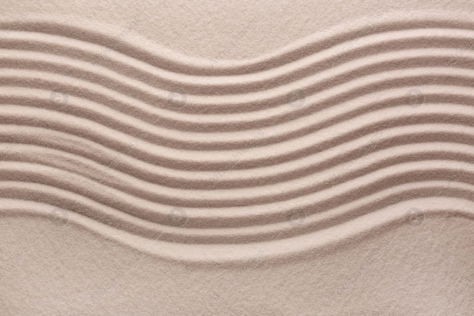 Photo of White sand with pattern as background, top view. Concept of zen and harmony