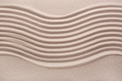 White sand with pattern as background, top view. Concept of zen and harmony