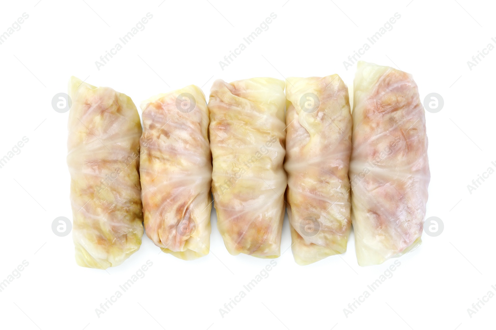 Photo of Uncooked stuffed cabbage rolls isolated on white, top view