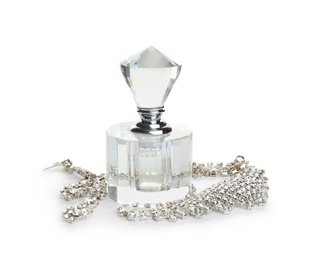 Photo of Glass bottle of perfume and luxury jewellery isolated on white