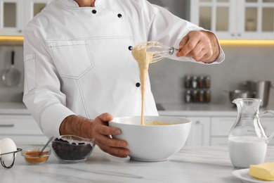 Professional chef making dough at white marble table indoors, closeup